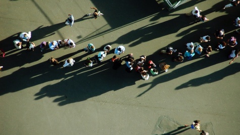 Birds-eye-view photograph of a long line outside a polling place.