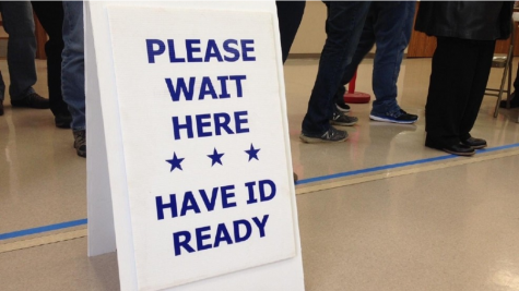"Please wait here, have ID ready" voting sign