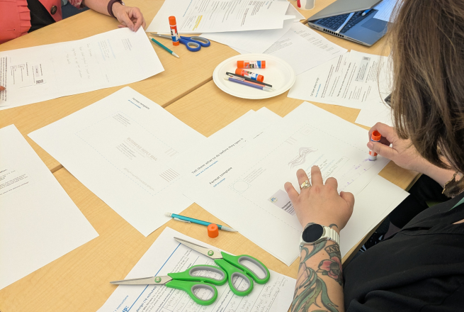 A person creating a paper prototype.
